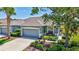 Well-maintained home with a two-car garage, verdant landscaping, and a welcoming facade at 4740 105Th E Ave, Parrish, FL 34219