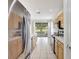 Bright kitchen features stainless steel appliances, tile floor, and a view to the lanai at 4740 105Th E Ave, Parrish, FL 34219