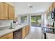 Well-maintained kitchen features wood cabinets, neutral countertops, essential appliances, and access to a patio at 4740 105Th E Ave, Parrish, FL 34219