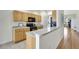 Bright kitchen area features wood cabinets and an extended breakfast bar at 4740 105Th E Ave, Parrish, FL 34219