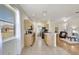 Well-lit kitchen featuring wood cabinetry, neutral countertops, essential appliances, and an open-concept layout at 4740 105Th E Ave, Parrish, FL 34219