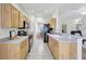 Functional kitchen boasts wood cabinets, neutral countertops, tile floors, and essential appliances at 4740 105Th E Ave, Parrish, FL 34219