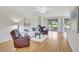 Cozy living room boasts natural light, comfortable seating, and hardwood floors at 4740 105Th E Ave, Parrish, FL 34219