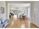 Open-concept living space showcasing hardwood floors, dining area, and a seamless flow into the living room at 4740 105Th E Ave, Parrish, FL 34219