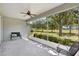 Screened patio with comfortable seating offering panoramic views of the lush green lawn at 4740 105Th E Ave, Parrish, FL 34219