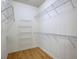 Spacious walk-in closet featuring laminate floors and metal shelves for ample storage in an organized space at 4740 105Th E Ave, Parrish, FL 34219