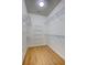 Walk-in closet with laminate floors featuring metal shelves for optimized storage and organization at 4740 105Th E Ave, Parrish, FL 34219