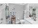Well-lit bathroom features shower, toilet, vanity with a sink, and neutral-toned decor at 4801 Osprey S Dr # 405, St Petersburg, FL 33711