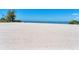 Expansive community beach with pristine white sand and the ocean in the distance at 4801 Osprey S Dr # 405, St Petersburg, FL 33711