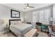Cozy bedroom with queen-size bed, ceiling fan and wooden desk with natural light from large window at 4801 Osprey S Dr # 405, St Petersburg, FL 33711