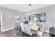 Stylish dining room featuring a contemporary chandelier and a view into the modern kitchen at 4801 Osprey S Dr # 405, St Petersburg, FL 33711