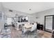 Open-concept dining area with modern lighting and a view into the kitchen at 4801 Osprey S Dr # 405, St Petersburg, FL 33711
