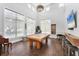 Spacious game room showcasing a pool table, seating, and large windows at 4801 Osprey S Dr # 405, St Petersburg, FL 33711