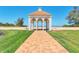 Beautifully landscaped community gazebo featuring brick pathway, columns, and open views at 4801 Osprey S Dr # 405, St Petersburg, FL 33711