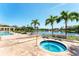 Community hot tub with lake view, lush landscaping, and a charming pergola in the background at 4801 Osprey S Dr # 405, St Petersburg, FL 33711