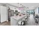 Modern kitchen with white cabinets, stainless appliances, and a quartz-topped island with barstool seating at 4801 Osprey S Dr # 405, St Petersburg, FL 33711