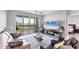 Living room featuring a TV, stylish furniture, sliding doors to a balcony and a glimpse into the bedroom at 4801 Osprey S Dr # 405, St Petersburg, FL 33711