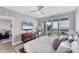 Main bedroom with balcony, water views, and a modern ceiling fan at 4801 Osprey S Dr # 405, St Petersburg, FL 33711