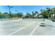 Community tennis court with lights surrounded by trees at 4801 Osprey S Dr # 405, St Petersburg, FL 33711