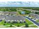 Picturesque aerial view of the community with a pond, highway, and well-maintained townhomes at 5155 78Th St E Cir, Bradenton, FL 34203