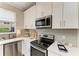 Kitchen features stainless steel appliances, white countertops, and cabinets at 5155 78Th St E Cir, Bradenton, FL 34203