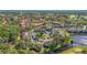 Aerial view of the community highlighting multiple buildings, mature trees, and well-maintained parking at 5291 Willow Links # 54, Sarasota, FL 34235