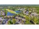 Aerial view of the condo community featuring mature trees, common grounds, and a scenic lake at 5291 Willow Links # 54, Sarasota, FL 34235