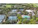 Expansive aerial view of the community with tennis courts, a pool, and parking at 5291 Willow Links # 54, Sarasota, FL 34235
