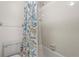 Clean bathroom with a tiled shower and seashell-themed shower curtain at 5291 Willow Links # 54, Sarasota, FL 34235