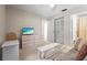 Bright bedroom with TV, neutral colors, a closet and a comfortable sofa at 5291 Willow Links # 54, Sarasota, FL 34235