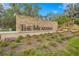 Stone entrance sign for 'The Meadows' surrounded by landscaped greenery and plantings at 5291 Willow Links # 54, Sarasota, FL 34235
