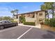 Condo building with well-maintained landscaping, covered entrances, and ample parking at 5291 Willow Links # 54, Sarasota, FL 34235