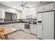 Bright kitchen featuring white cabinets, tile flooring, and modern appliances at 5291 Willow Links # 54, Sarasota, FL 34235