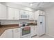 Kitchen features white cabinetry, stainless appliances, and ample counter space at 5291 Willow Links # 54, Sarasota, FL 34235