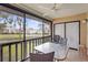 Screened lanai with peaceful water views and comfortable seating at 5291 Willow Links # 54, Sarasota, FL 34235