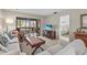 Cozy living room showcasing a flat screen TV, screen enclosed lanai and access to the bedroom at 5291 Willow Links # 54, Sarasota, FL 34235
