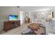 Open concept living room and dining area with neutral colors, tv, and comfortable seating at 5291 Willow Links # 54, Sarasota, FL 34235