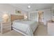 Serene main bedroom with a woven headboard, soft lighting, and closet access at 5291 Willow Links # 54, Sarasota, FL 34235
