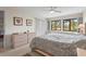 Tranquil bedroom features a large window, ceiling fan, and neutral décor at 5291 Willow Links # 54, Sarasota, FL 34235