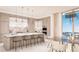Modern kitchen with marble counters, island with seating, and high-end appliances at 555 Quay Cmn # 1601, Sarasota, FL 34236