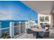 Spacious balcony with comfortable seating offering panoramic views of the ocean and city skyline at 555 Quay Cmn # 804, Sarasota, FL 34236