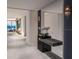 Beautiful hallway with tiled floors, modern lighting, and a glimpse of the ocean view beyond at 555 Quay Cmn # 804, Sarasota, FL 34236
