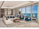Bright living room with expansive windows showcasing the city and ocean views, plus modern furnishings at 555 Quay Cmn # 804, Sarasota, FL 34236