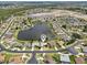 Beautiful aerial view of a residential neighborhood with a central lake and well-maintained landscaping at 5596 Sabal Trace Dr, North Port, FL 34287