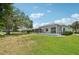 Well-maintained backyard with a screened-in lanai and lake views at 5596 Sabal Trace Dr, North Port, FL 34287