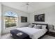 Cozy bedroom featuring a ceiling fan, and a large window at 5596 Sabal Trace Dr, North Port, FL 34287