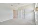 Bright, airy bedroom with neutral carpet, ceiling fan, and natural light from a window at 5596 Sabal Trace Dr, North Port, FL 34287