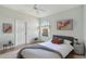 Light-filled bedroom featuring wood floors, bright decor, and a ceiling fan at 5596 Sabal Trace Dr, North Port, FL 34287