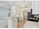 Open kitchen with white cabinets, tile flooring, and a breakfast bar at 5596 Sabal Trace Dr, North Port, FL 34287