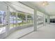 Enclosed lanai with panoramic views of the lake and surrounding greenery at 5596 Sabal Trace Dr, North Port, FL 34287